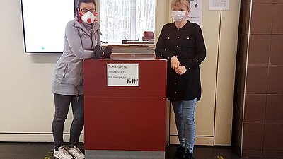 You can see two women with face masks at customs clearance.